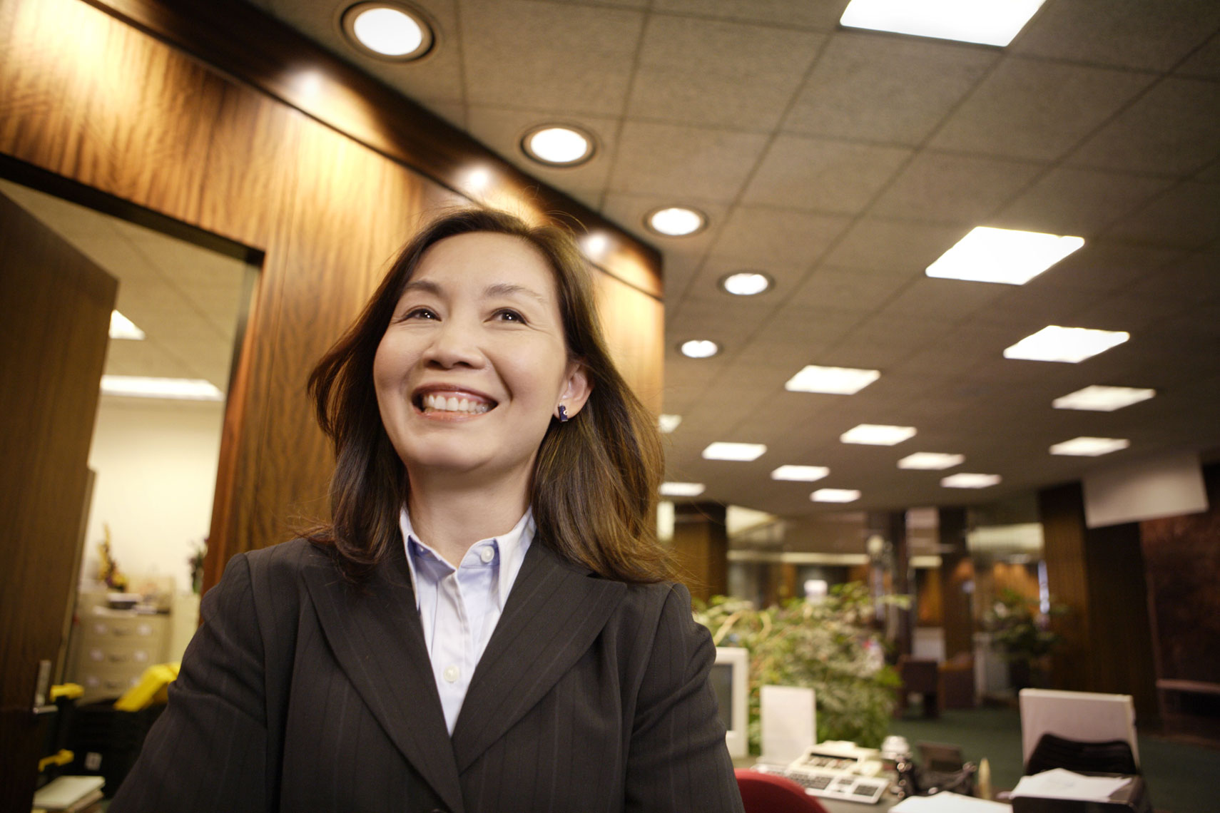 Environmental portrait of an Asian woman bank employee